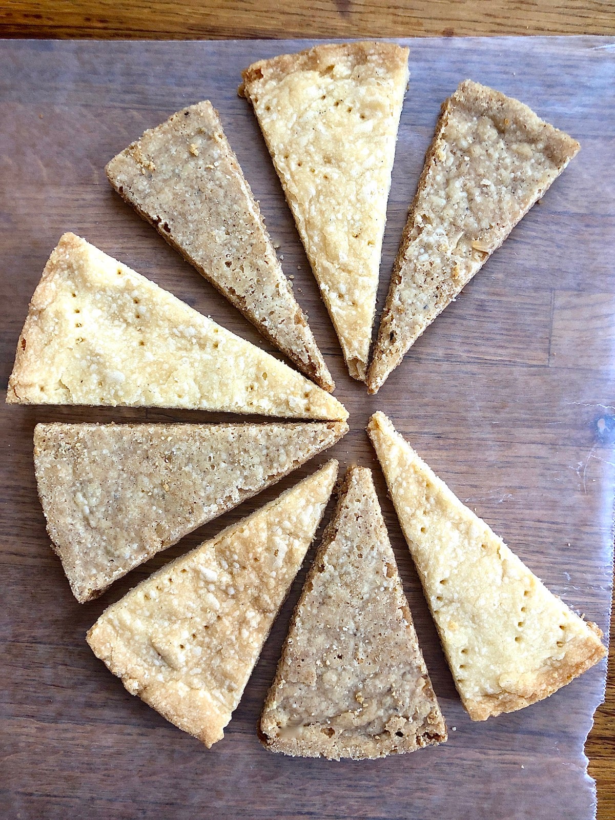 Shortbread wedges on a counter, some made with brown butter, some with standard butter.